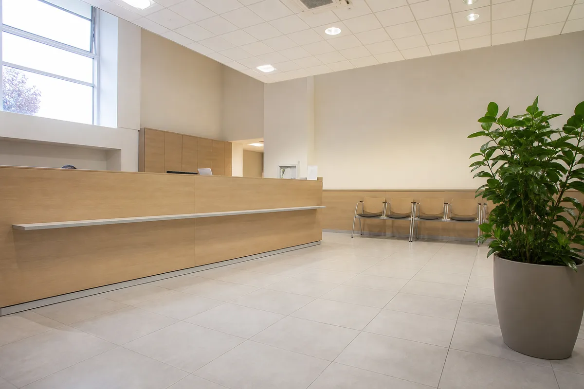 Comptoir d&rsquo;accueil d&rsquo;une mairie française avec plante verte et rangée de chaises